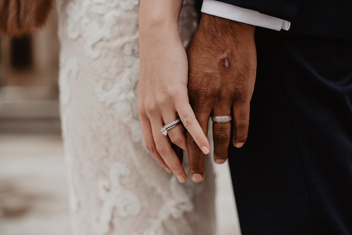 Two Persons Wearing Silver-colored Rings